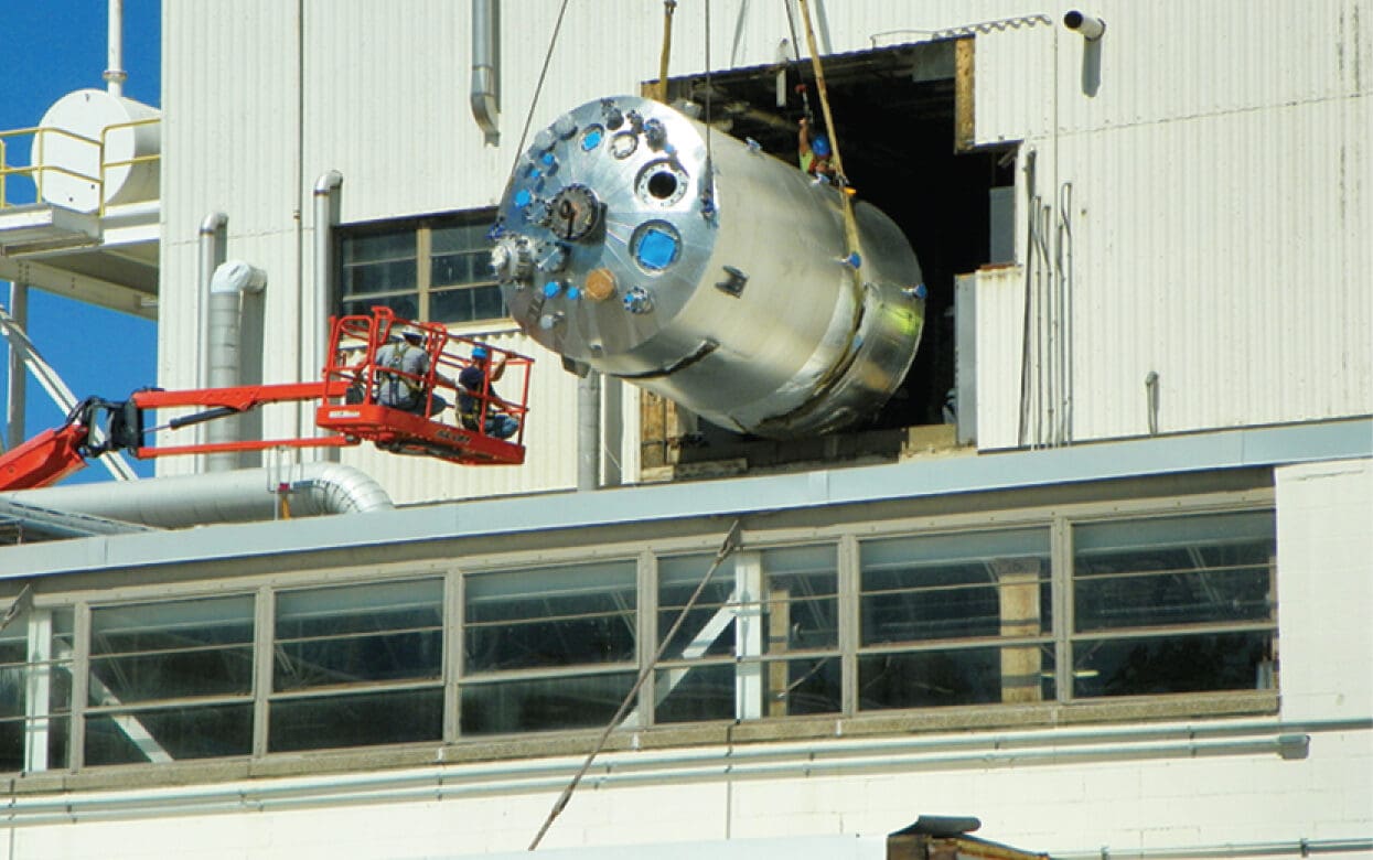 Stainless steel welded process piping and reactor installation showing industrial piping solutions at a chemical plant
