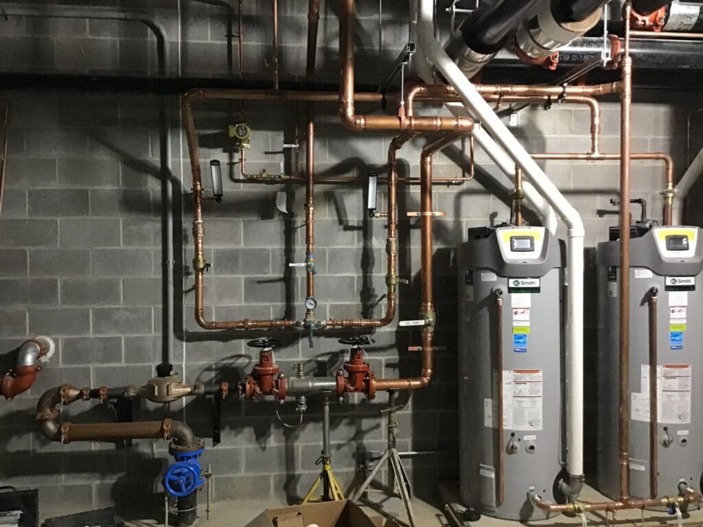 Copper water piping and two commercial water heaters installed by Wilkes
