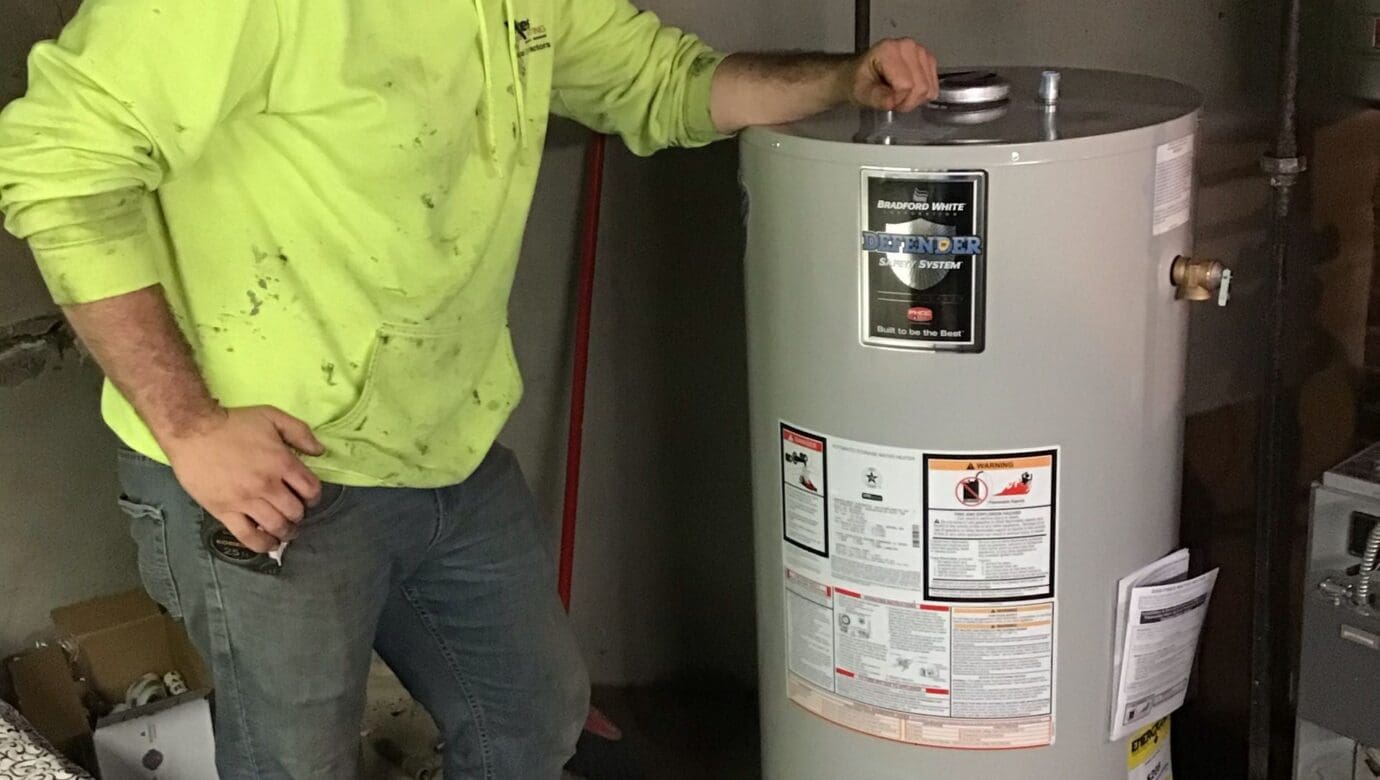 Wilkes plumber beside a newly installed residential water heater
