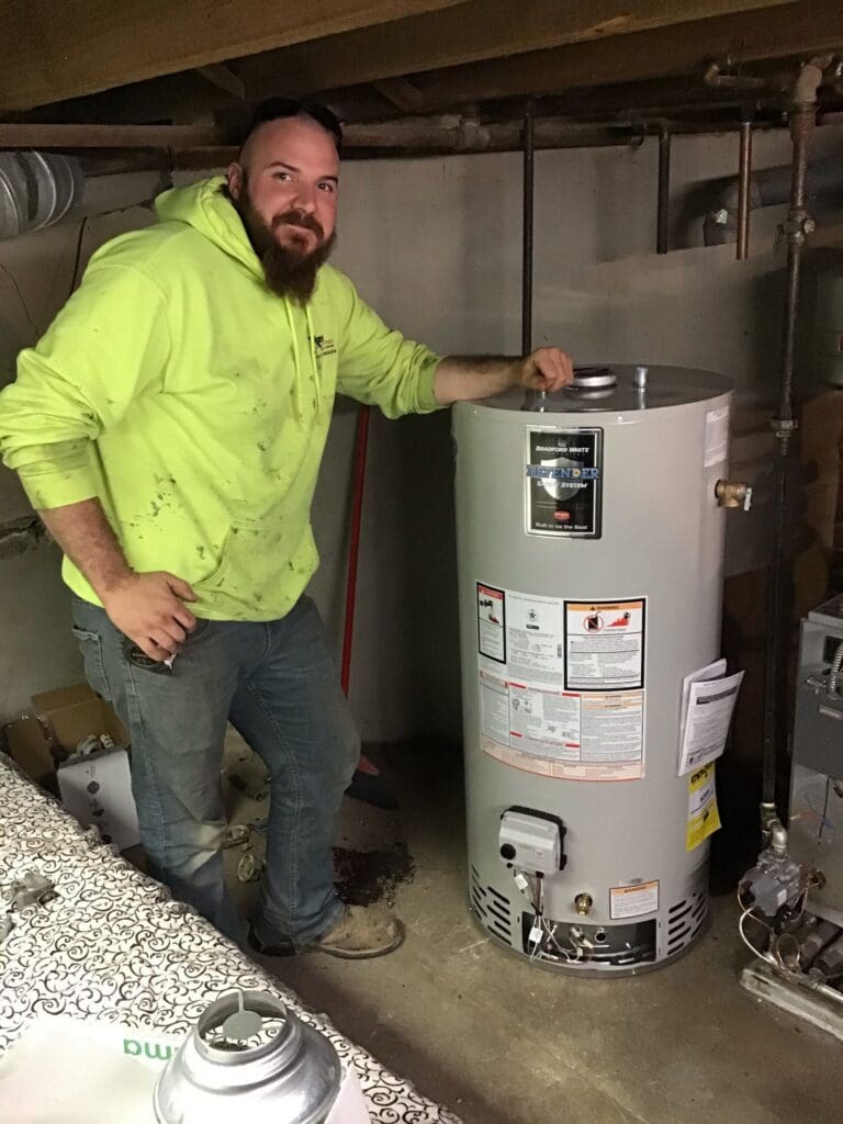 Wilkes plumber beside a newly installed residential water heater