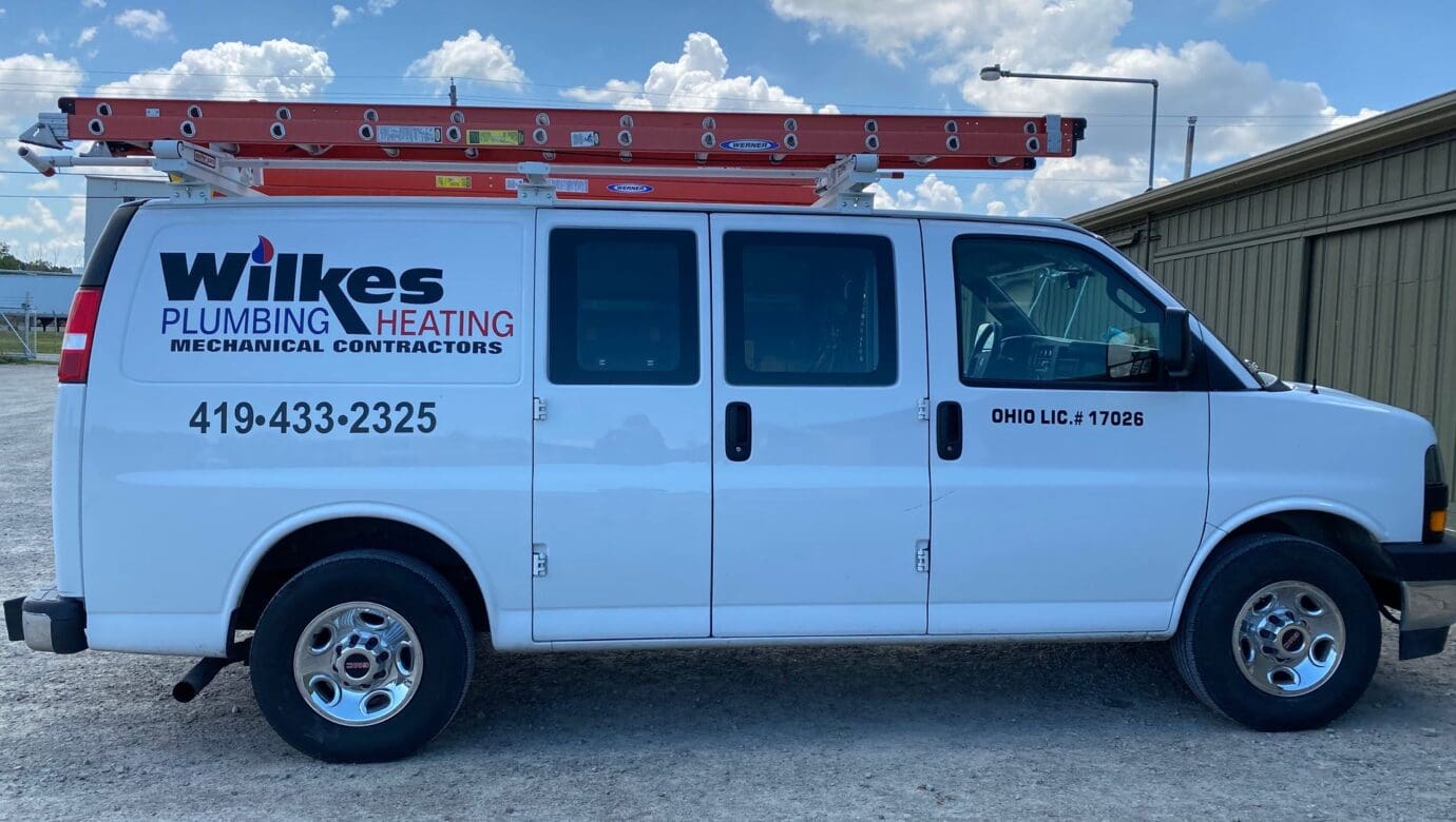 Wilkes Plumbing & Heating service van with a roof ladder rack