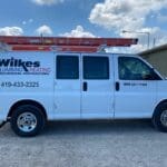 Wilkes Plumbing & Heating service van with a roof ladder rack