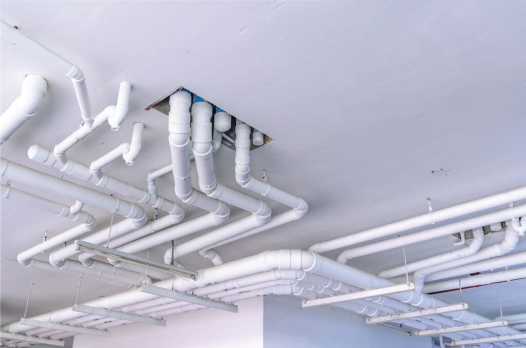 Insulated commercial plumbing piping installed below a ceiling by Wilkes