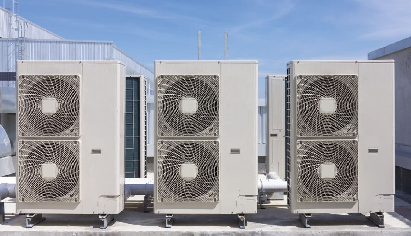 Technician performing commercial HVAC repair on a rooftop unit at an Ohio facility