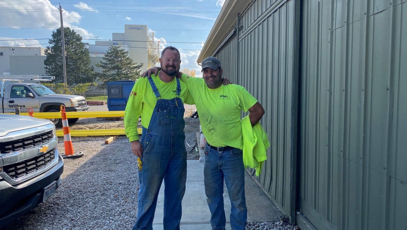 Two Wilkes field technicians outside the Huron shop