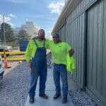 Two Wilkes field technicians outside the Huron shop