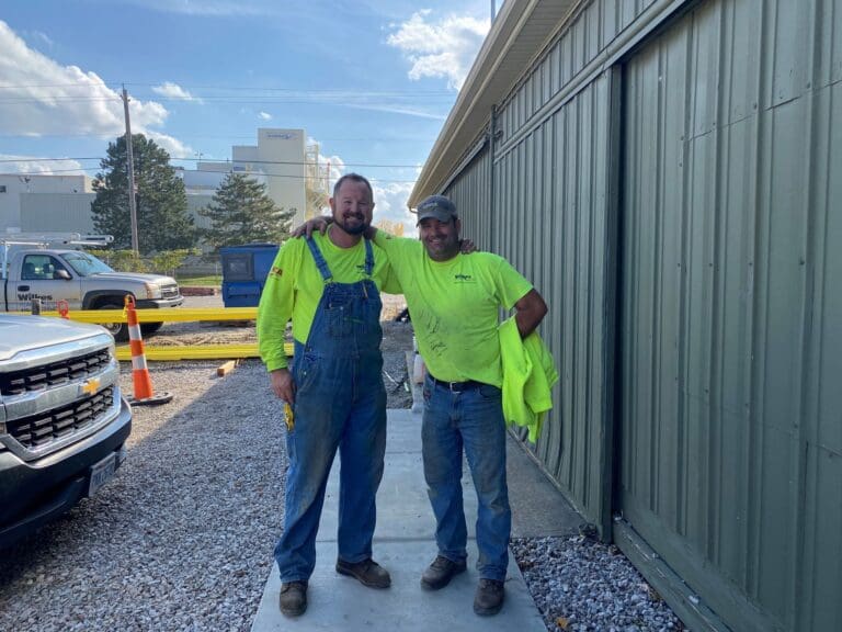 Two Wilkes field technicians outside the Huron shop