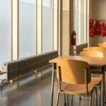 School classroom with hydronic fin-tube radiators under bright winter windows
